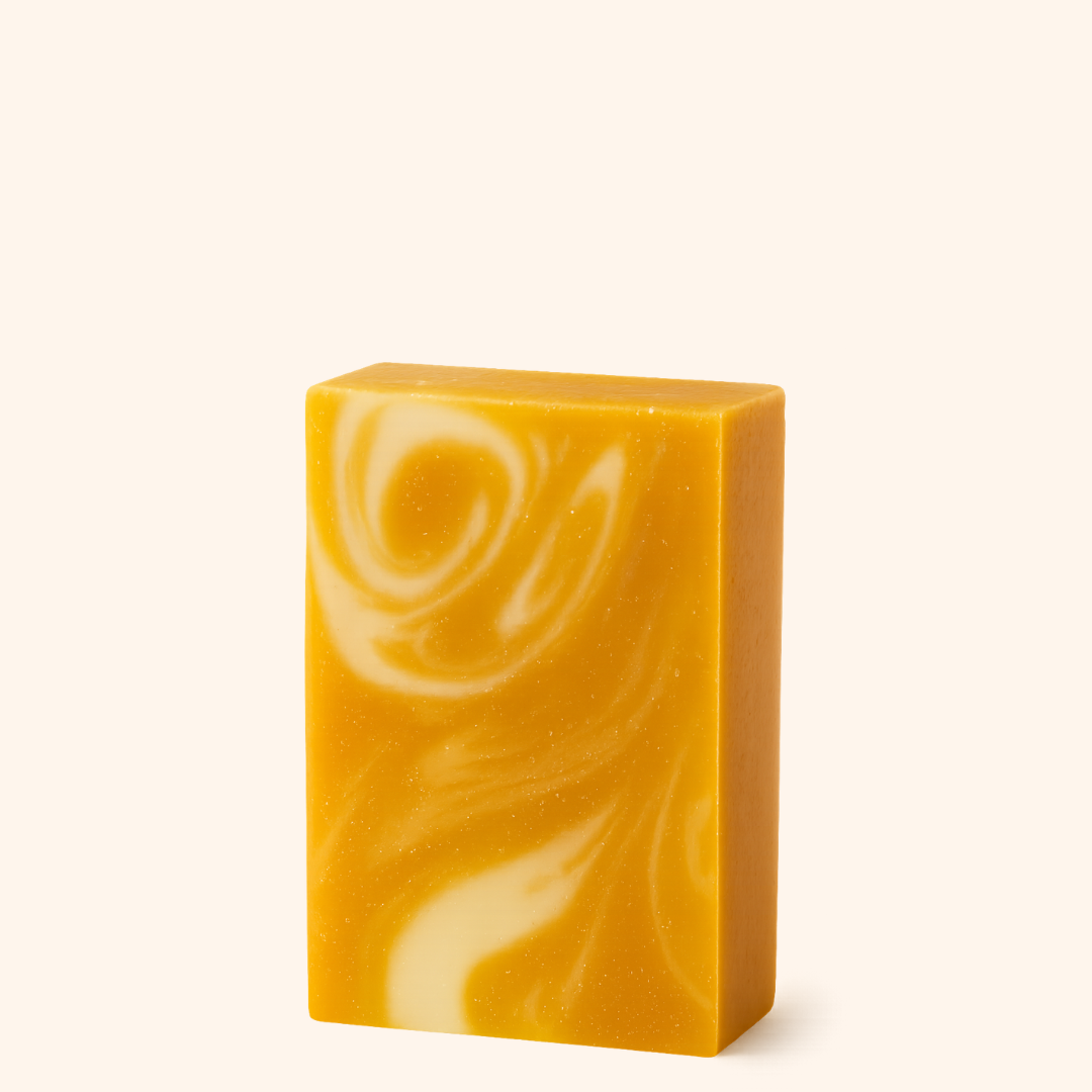 Yellow and white swirled soap bar on a white background