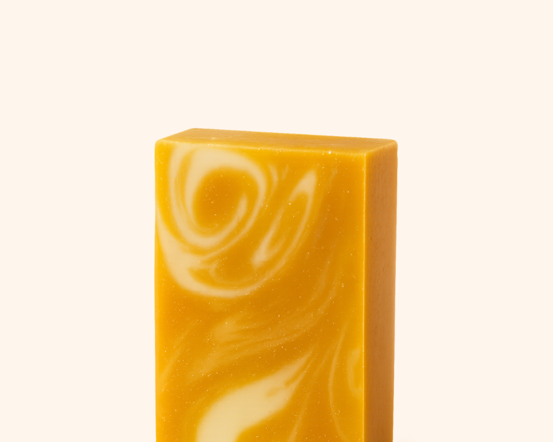 Yellow and white swirled soap bar on a white background