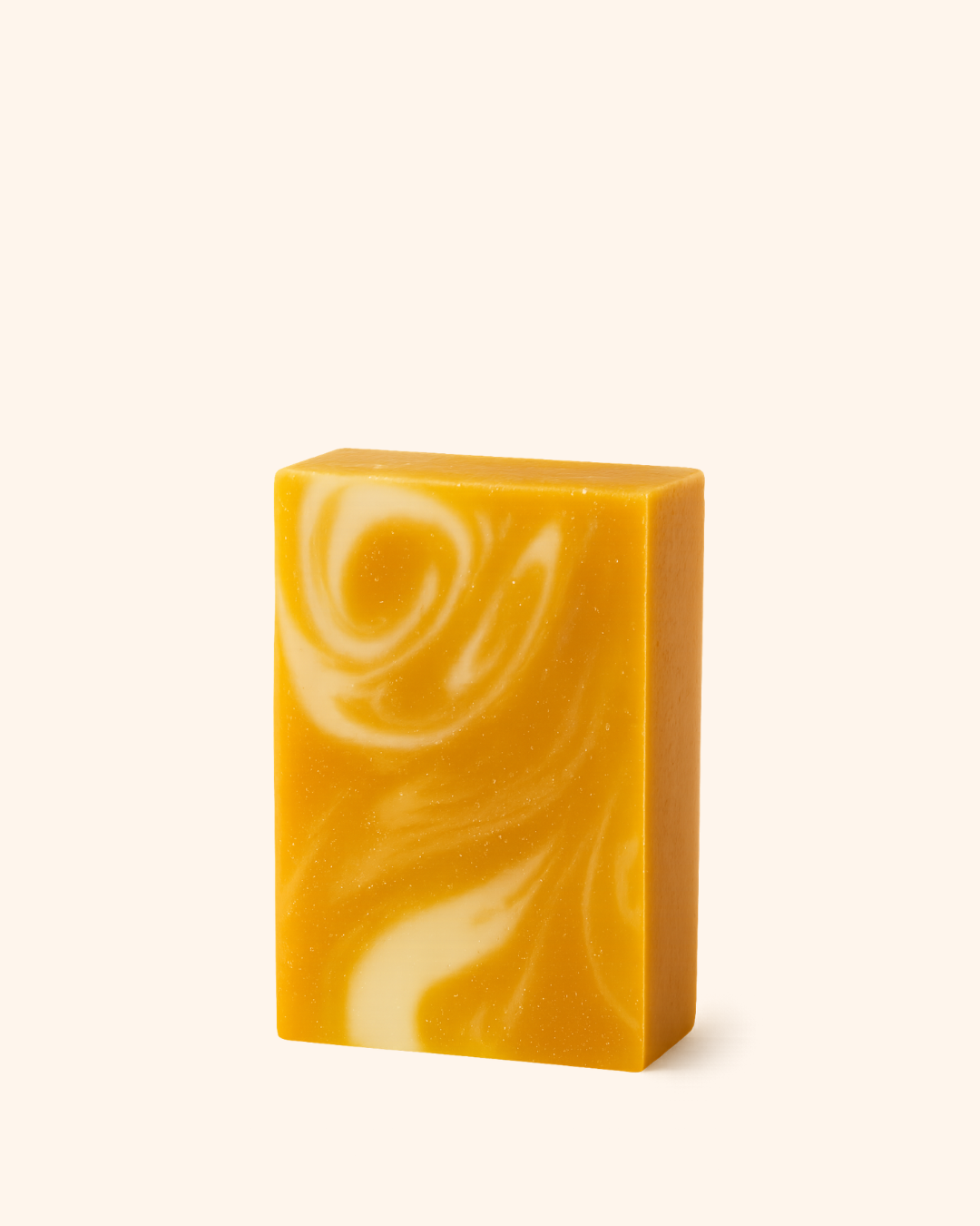 Yellow and white swirled soap bar on a white background