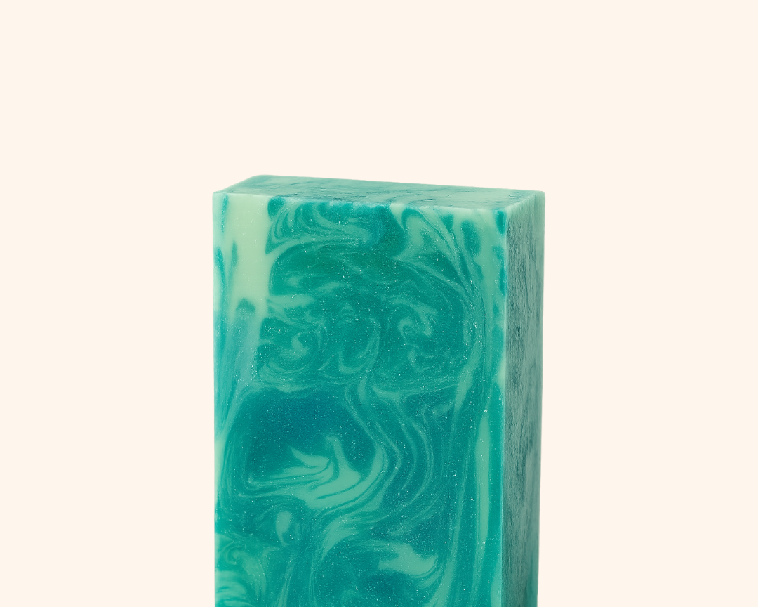 Green marbled soap bar on a white background
