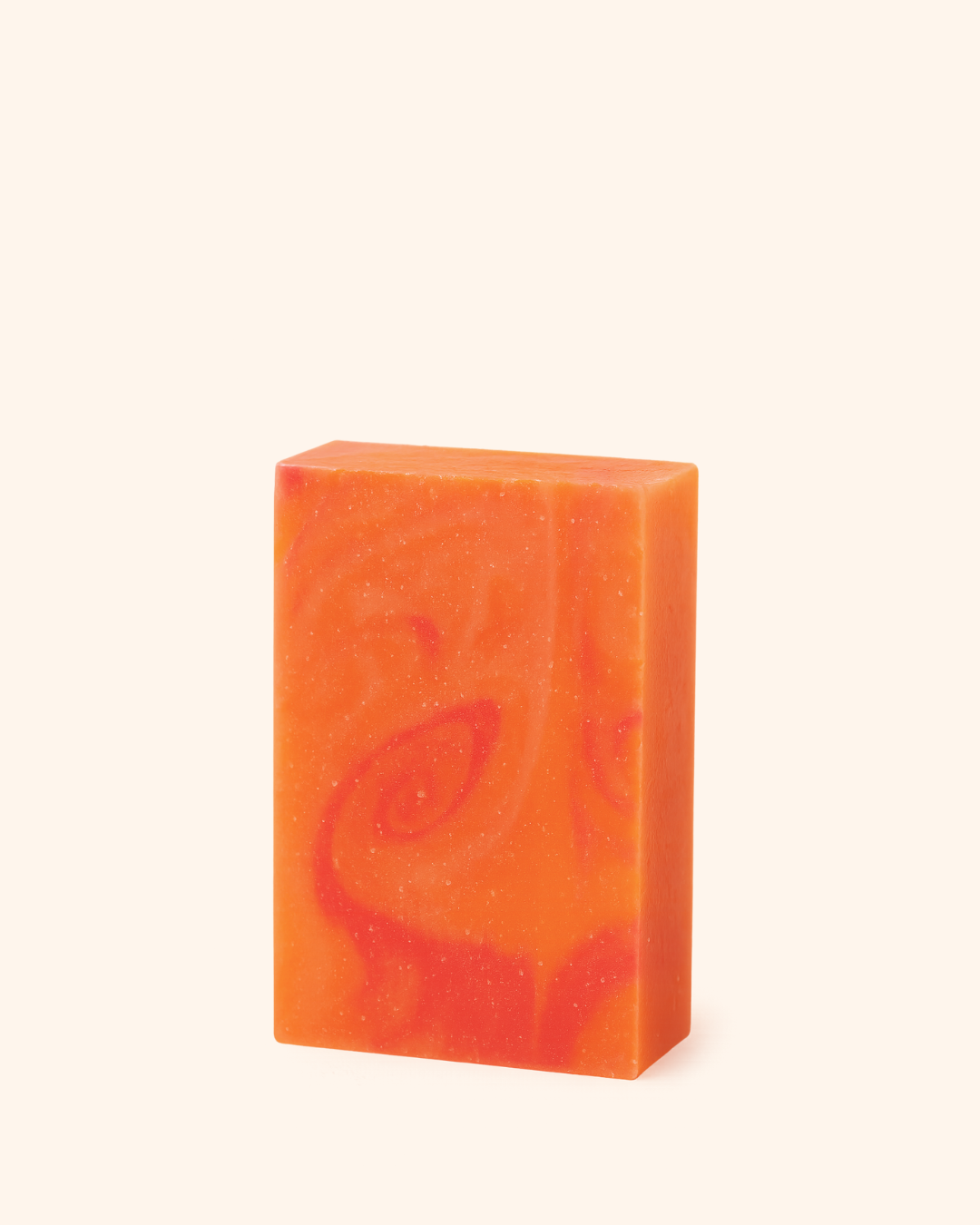 Orange soap bar with a leaf design on a white background