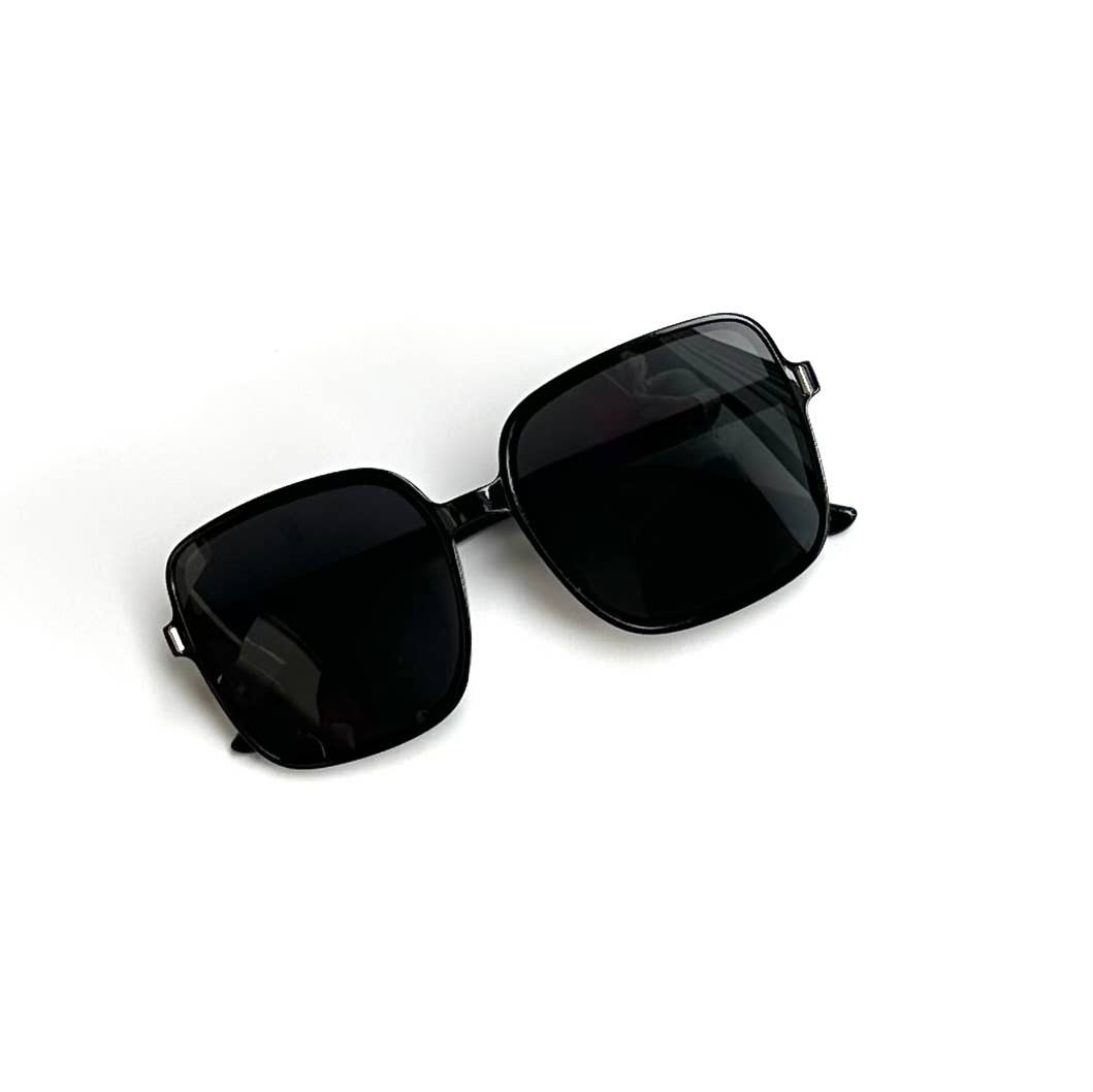 Oversized black framed black lenses sunglases folded front view