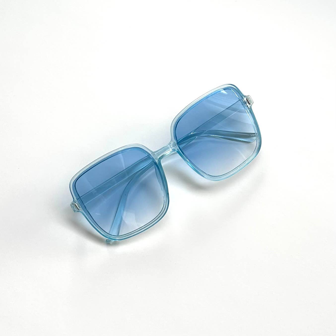 Oversized blue transparent framed sunglasses with blue lenses front view