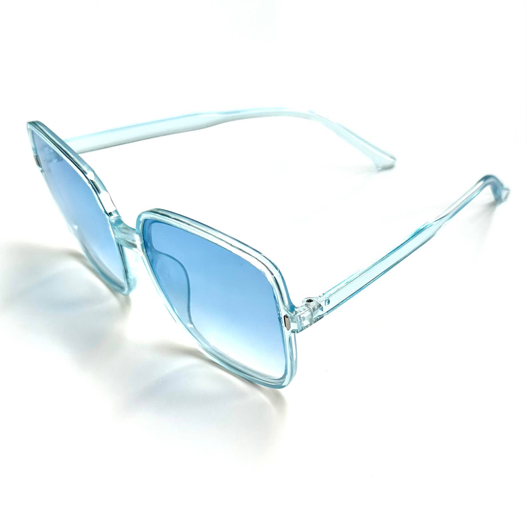 Oversized blue transparent framed sunglasses with blue lenses side view
