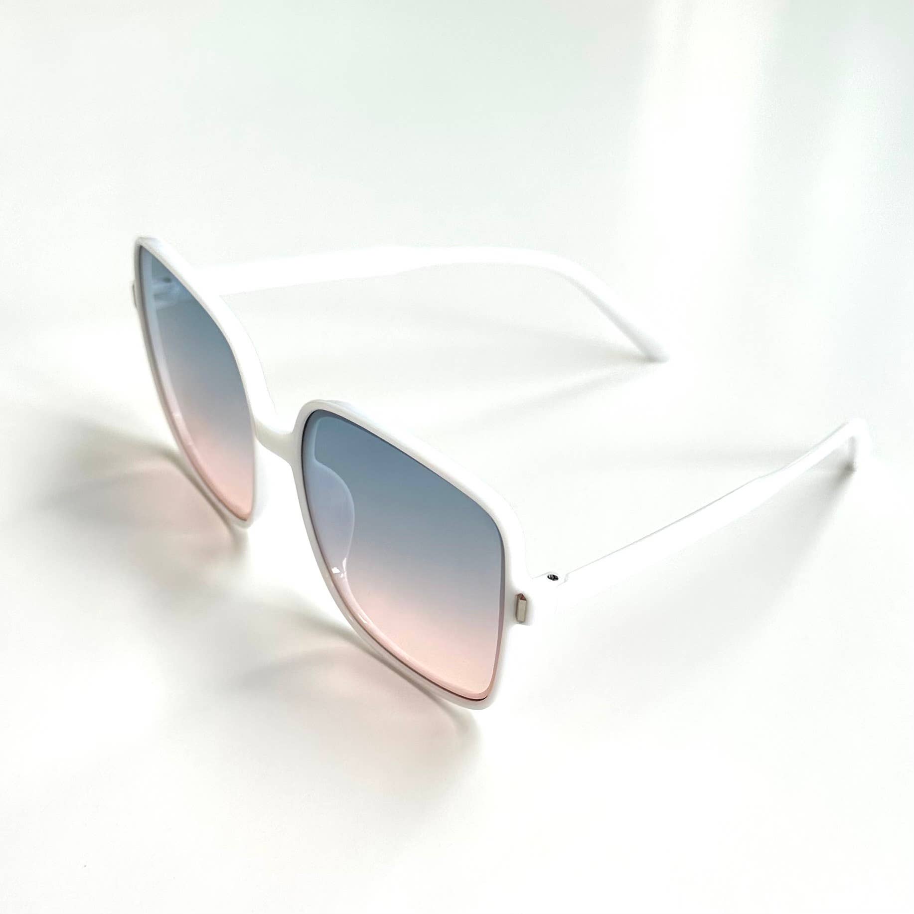 Oversized white framed sunglasses with gradient blue lenses side