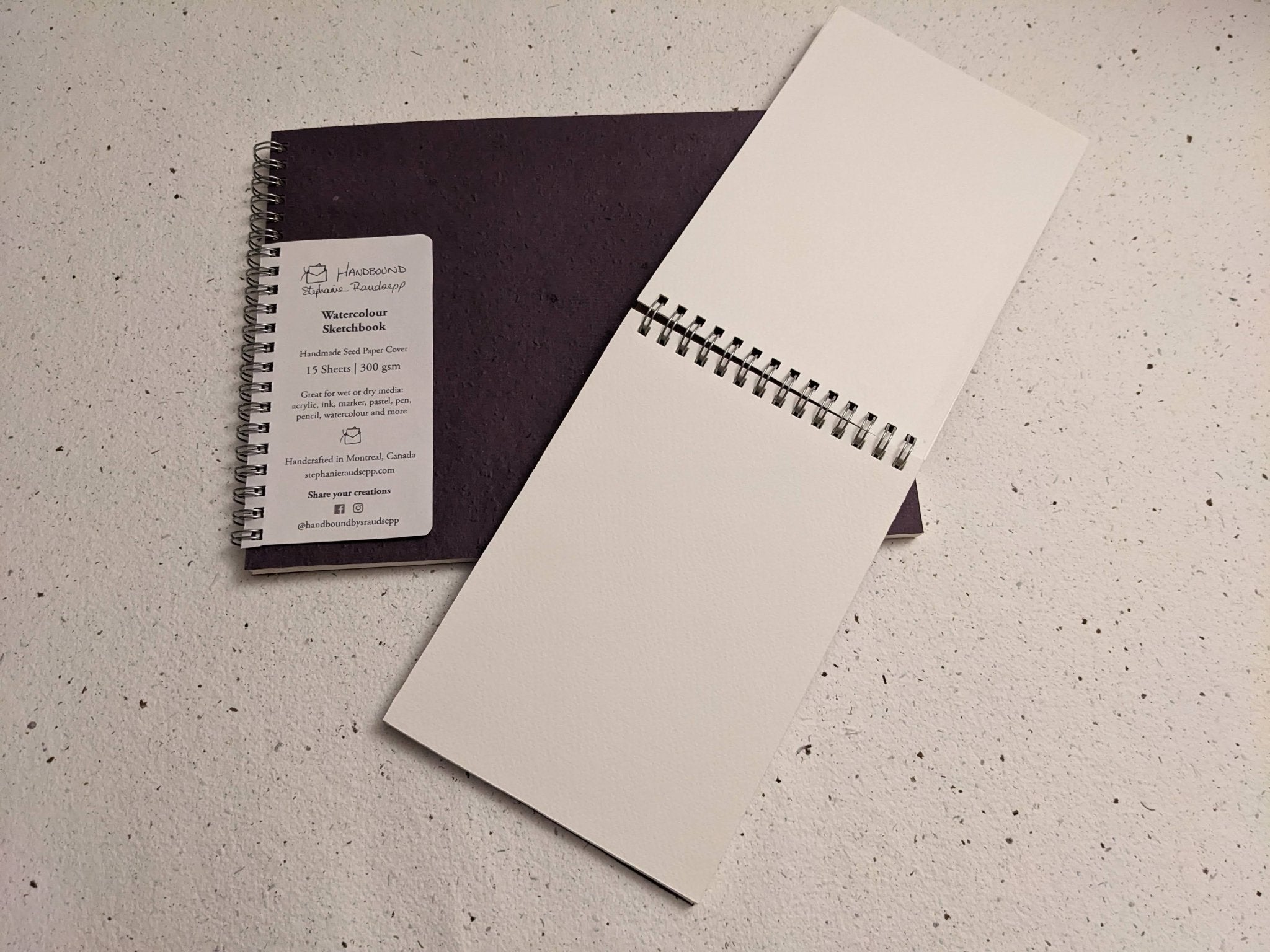 Two spiral-bound notebooks on a textured surface Large Plantable Watercolour Sketchbook by Creative Artifacts HQ