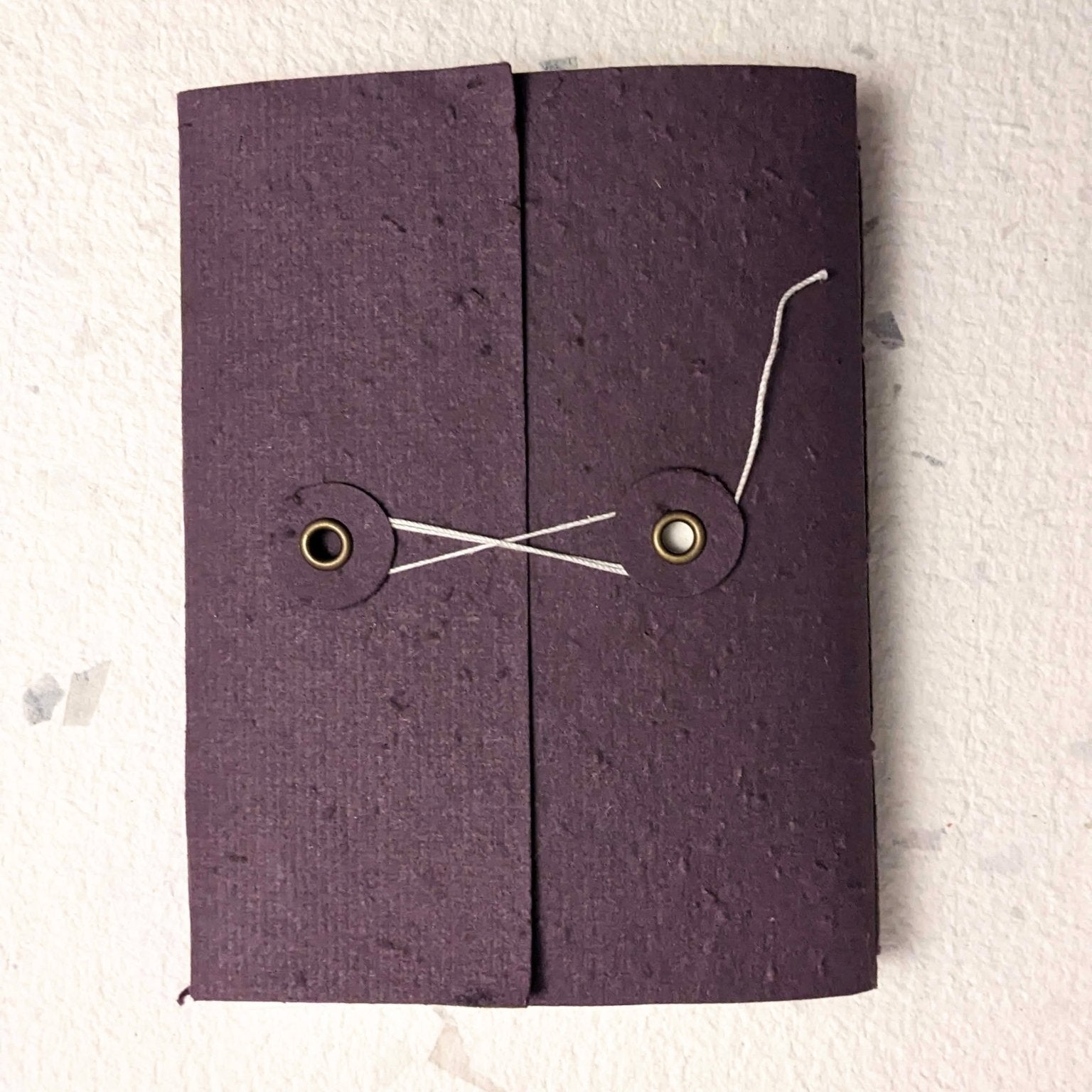 Purple fabric pouch with drawstring on a light grey background Creative Artifacts HQ