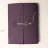 Purple fabric pouch with drawstring on a light grey background Creative Artifacts HQ