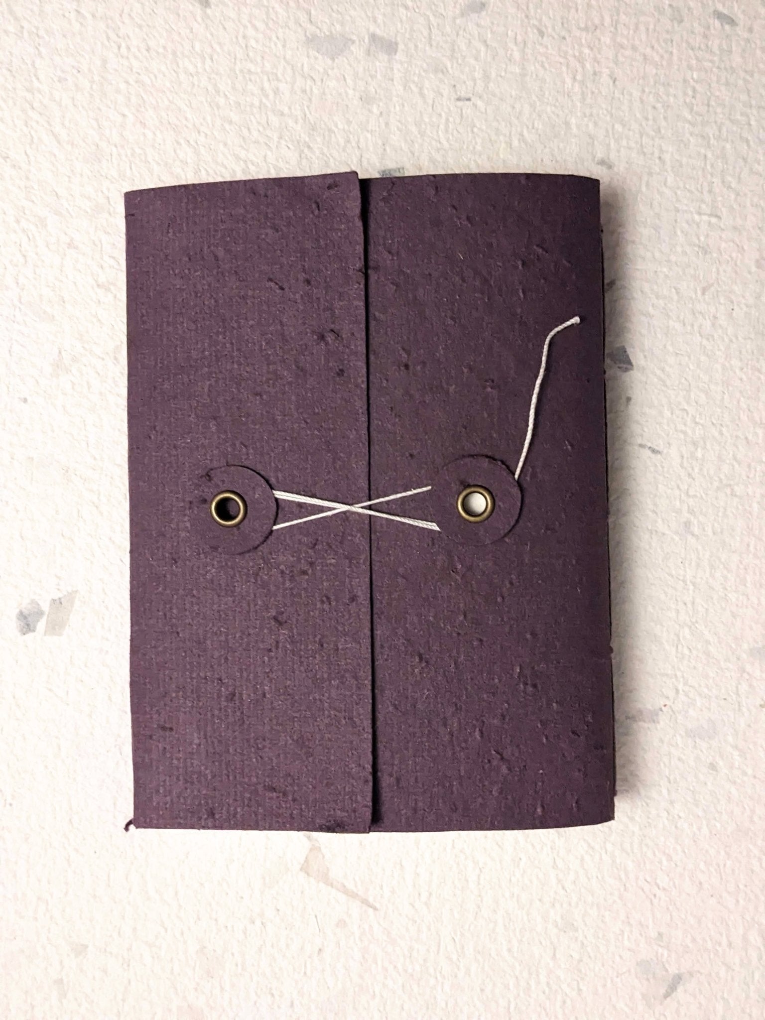 Purple fabric pouch with drawstring on a light grey background Creative Artifacts HQ