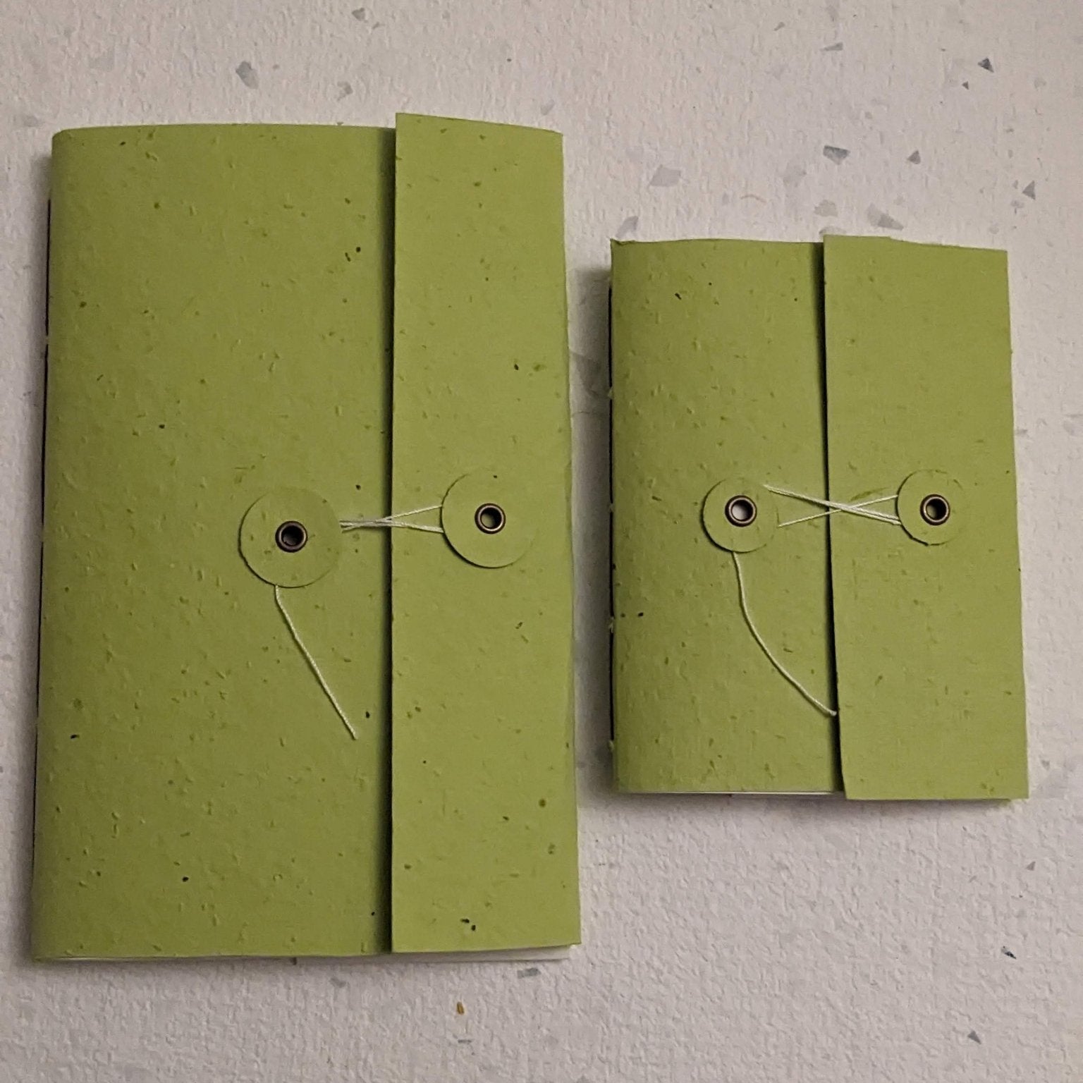 Two green fabric pouches with string closures on a light grey surface Creative Artifacts HQ plantable 