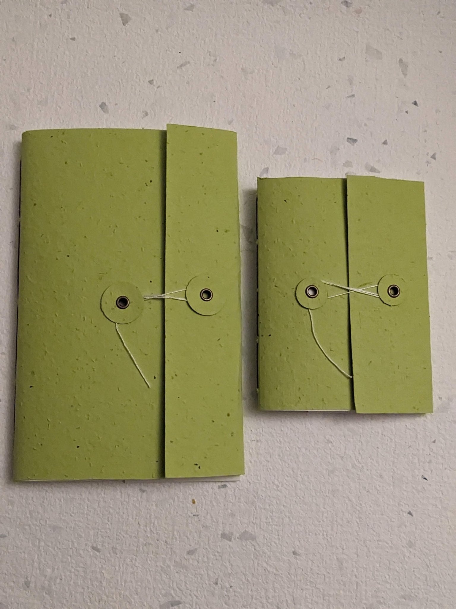 Two green fabric pouches with string closures on a light grey surface Creative Artifacts HQ plantable 