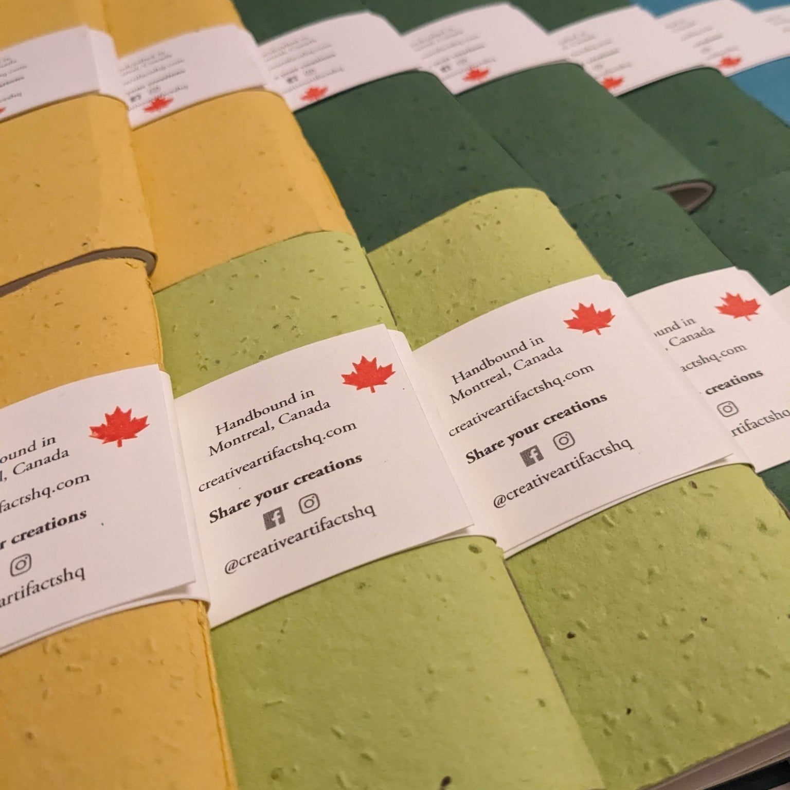 Row of small notebooks with visible brand labels on a grey surface Creative Artifacts HQ plantable 