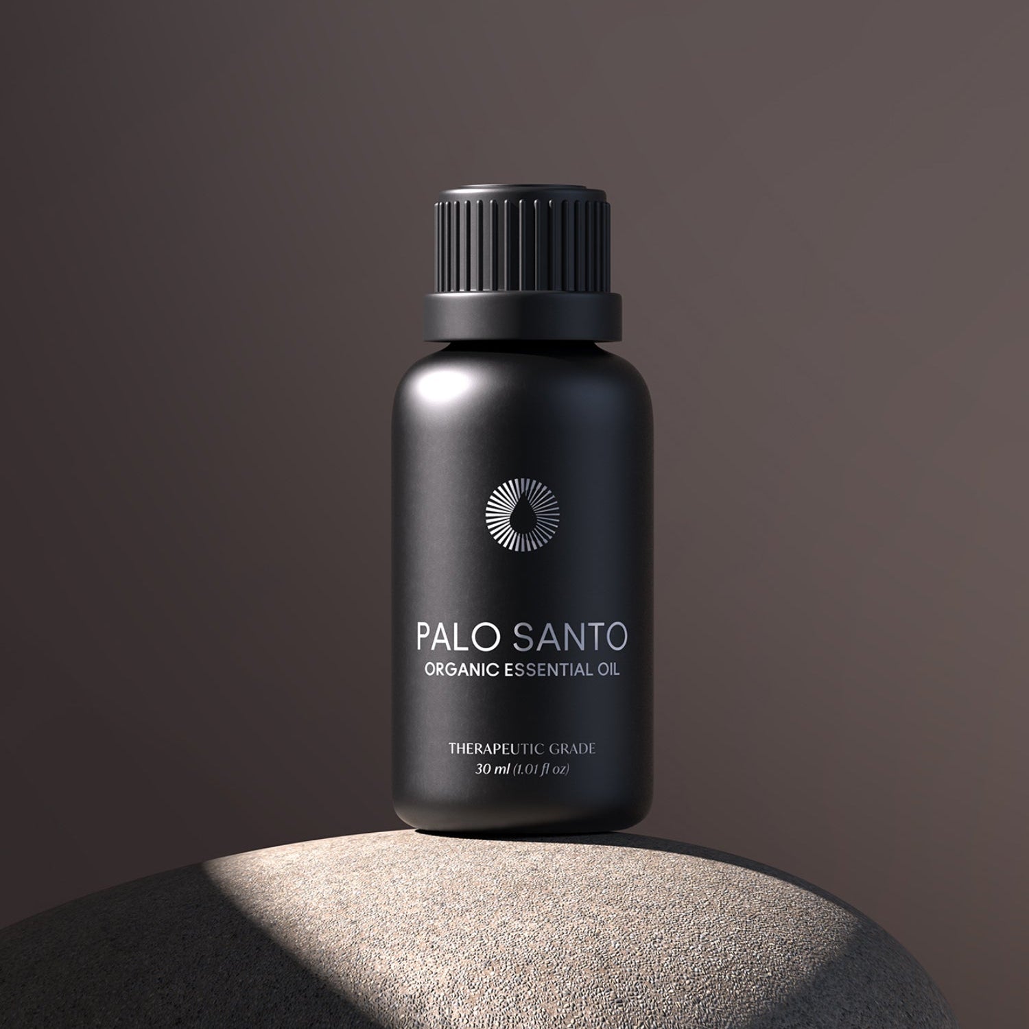 Black bottle of Palo Santo organic essential oil on a dark background