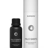 Black bottle and white cylindrical container of Bursera Palo Santo essential oil on a white background