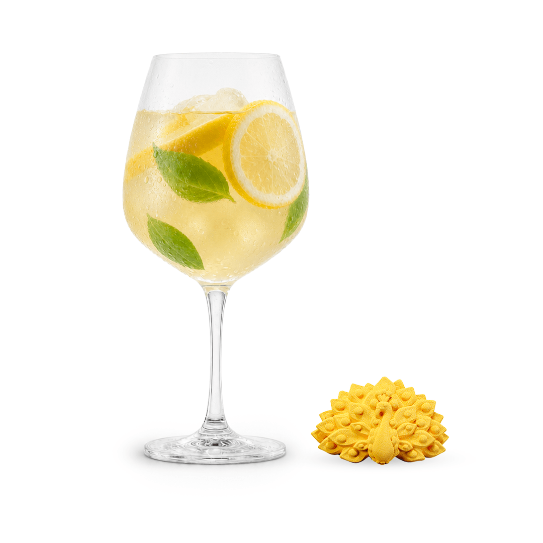 Wine glass with lemon slices and Posiedn Mocktail flavor bomb on a white background