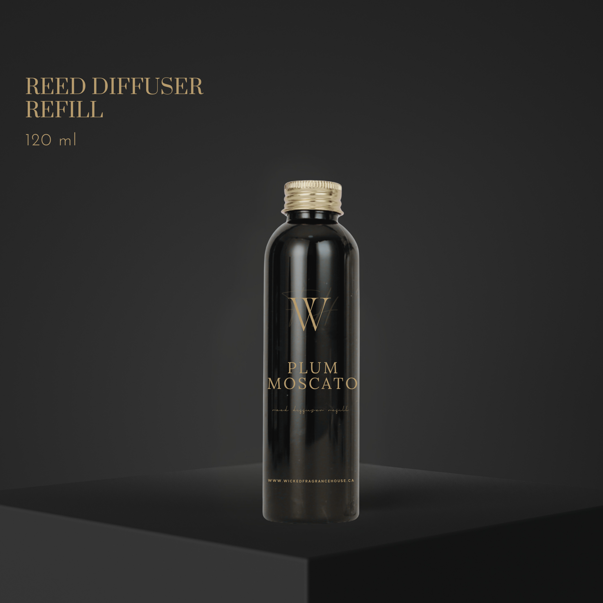 Black reed diffuser refill bottle with gold cap on a dark background