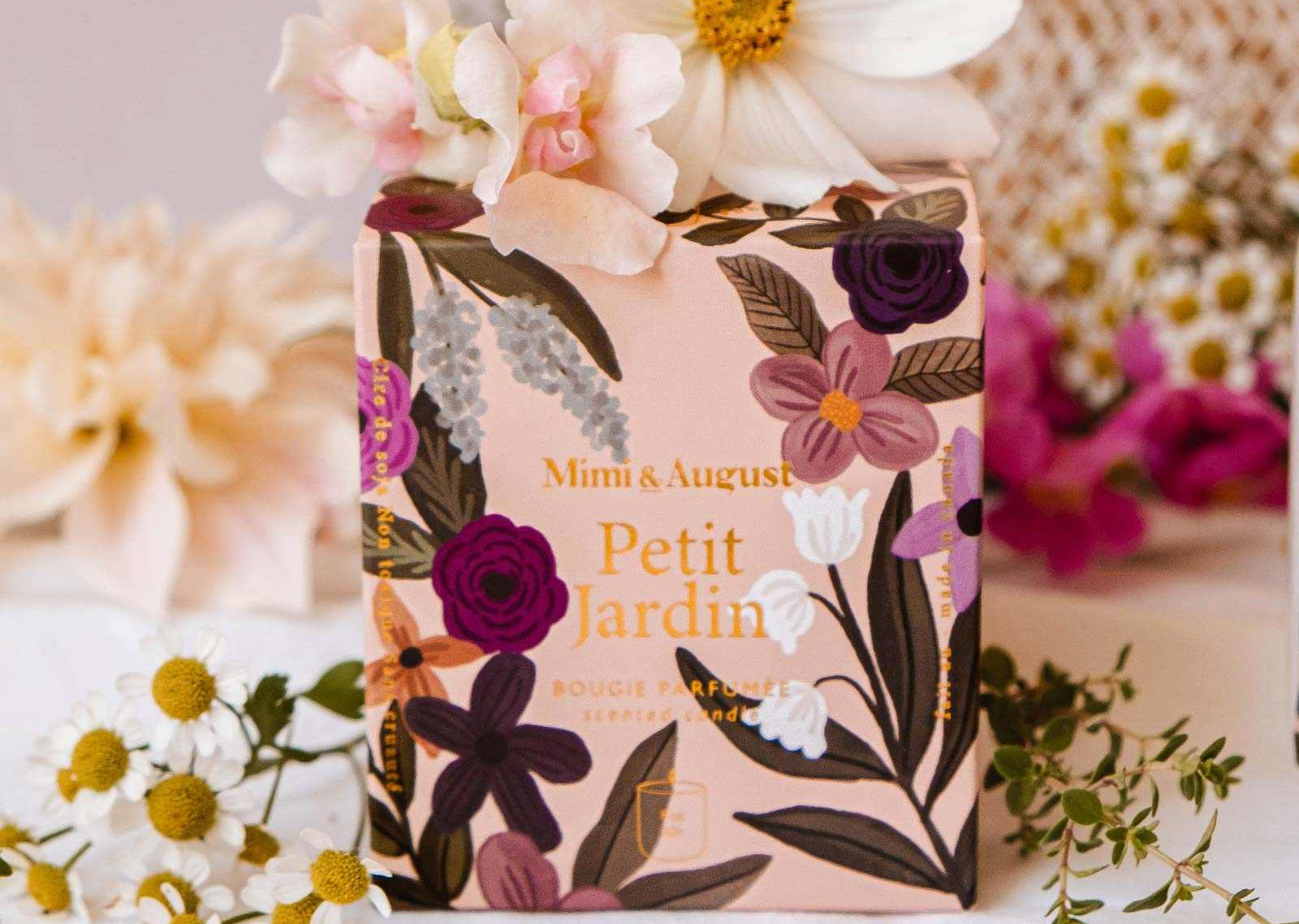 Floral soap bar with packaging on a white surface surrounded by flowers