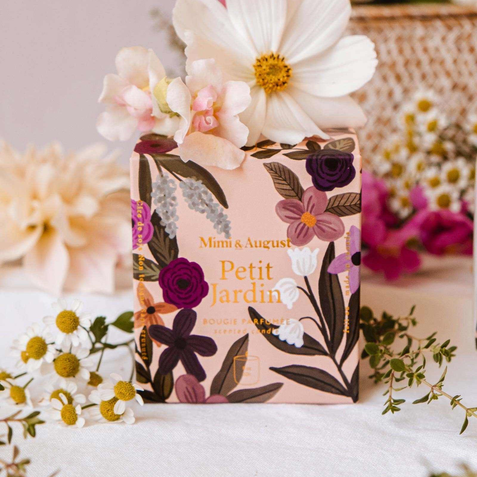 Floral soap bar with packaging on a white surface surrounded by flowers