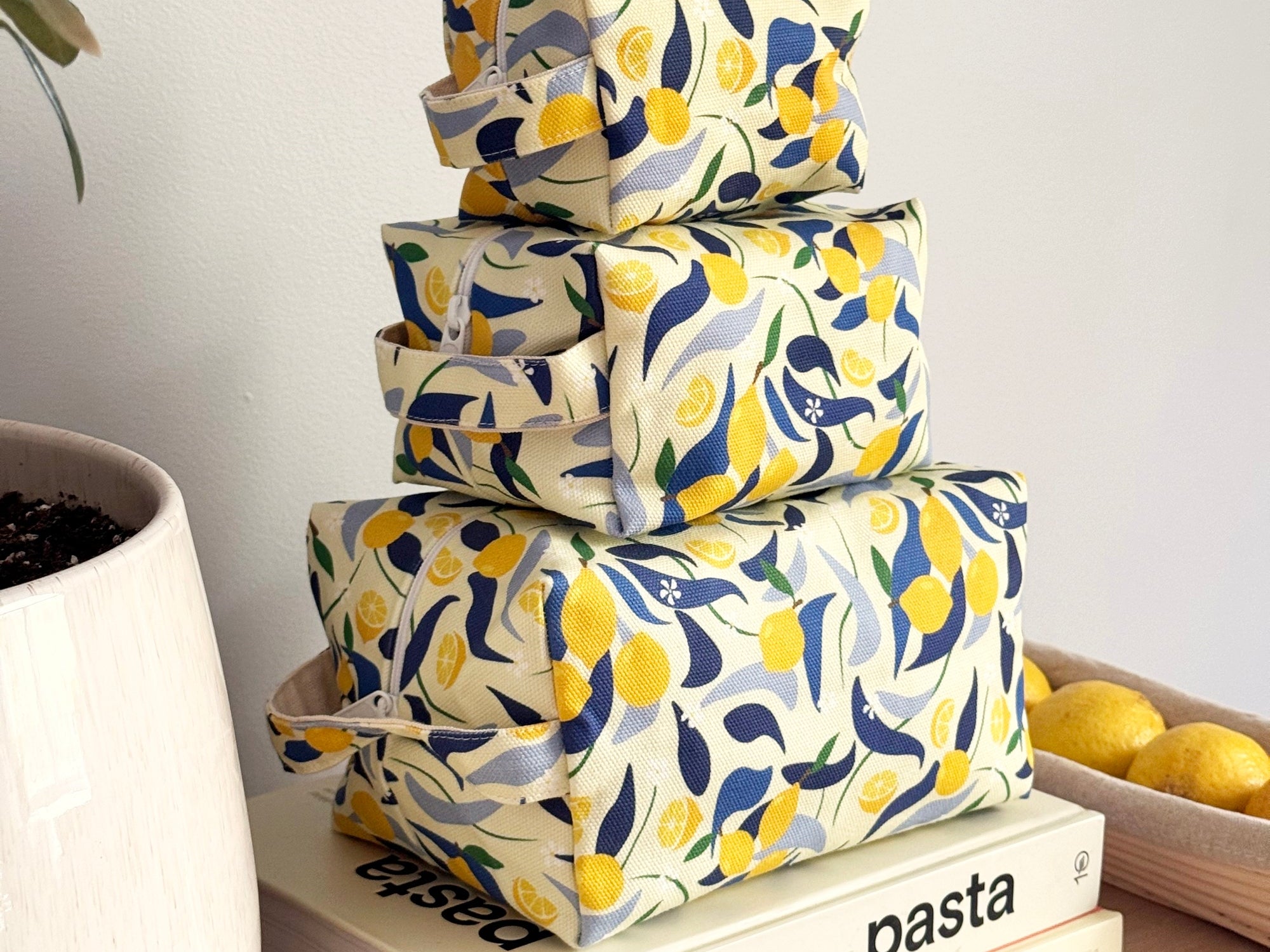 Three lemon themed stacked make up bags by Freon Collective