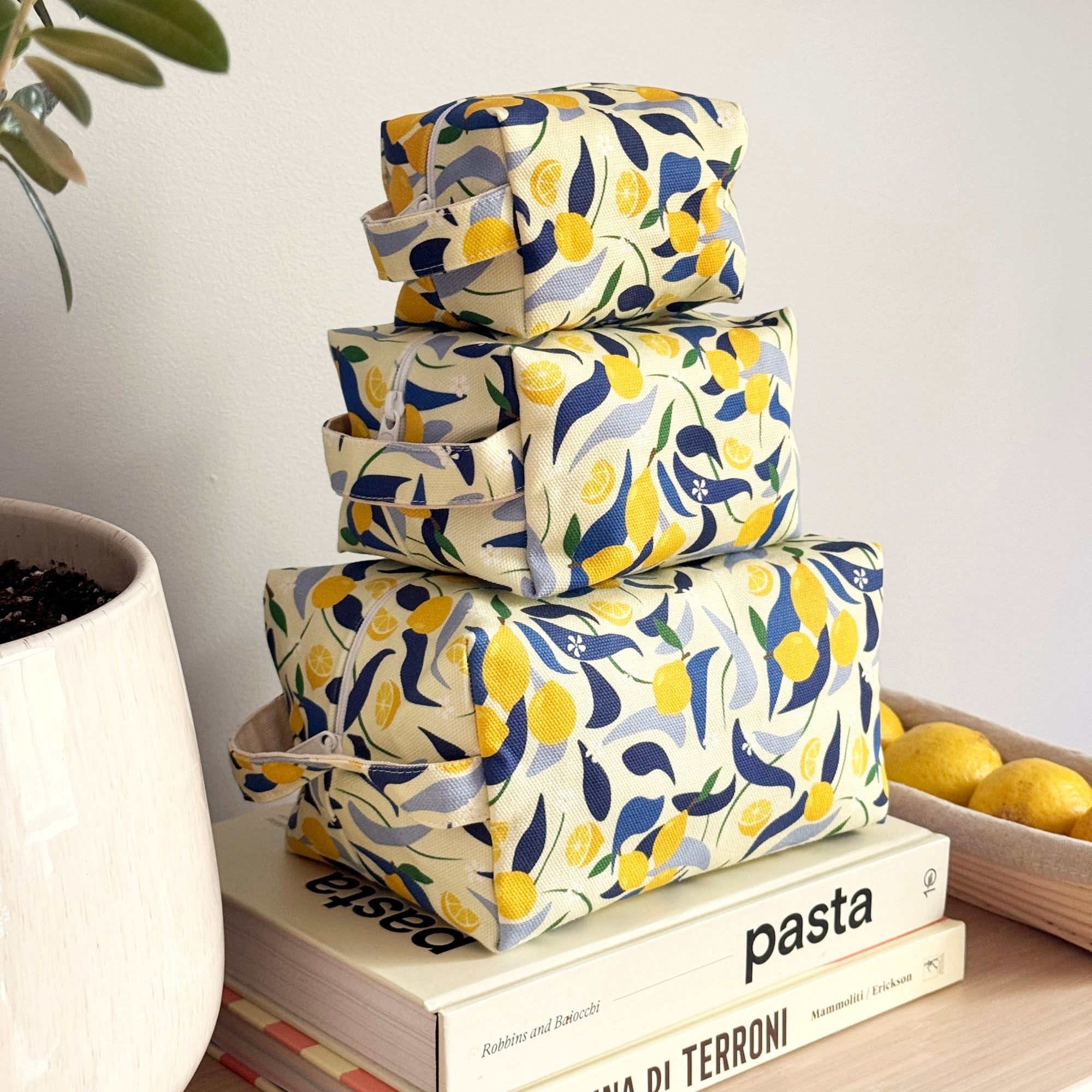 Three lemon themed stacked make up bags by Freon Collective