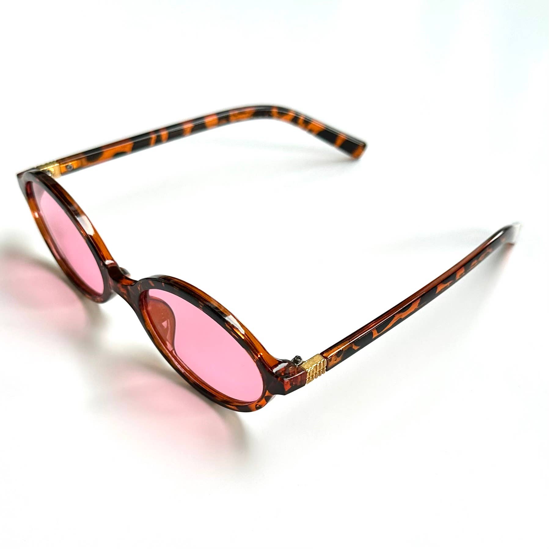 Pink tortoise framed oval sunglasses with rose open side view