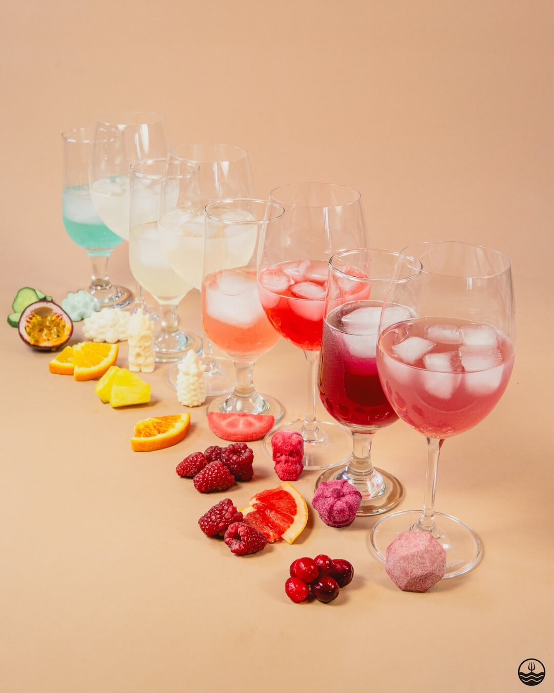 Poseidn Cocktail Variety Pack with cocktail bombs Assorted colorful cocktails with ice and fruits on a beige background