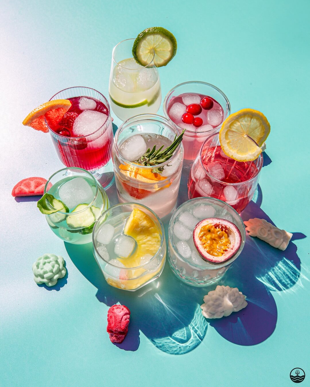 Assorted colorful cocktails with fruits and ice on a blue background from Poseidn Cocktail Variety Pack with cocktail bombs 