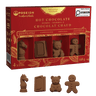 A red and gold box of Poseidon The Luxury Aesthetic Hot Chocolate Bombs, shown with four individual chocolate bombs in front on a black background. The chocolates are shaped like a chess piece, a book, a teddy bear, and a gingerbread man.