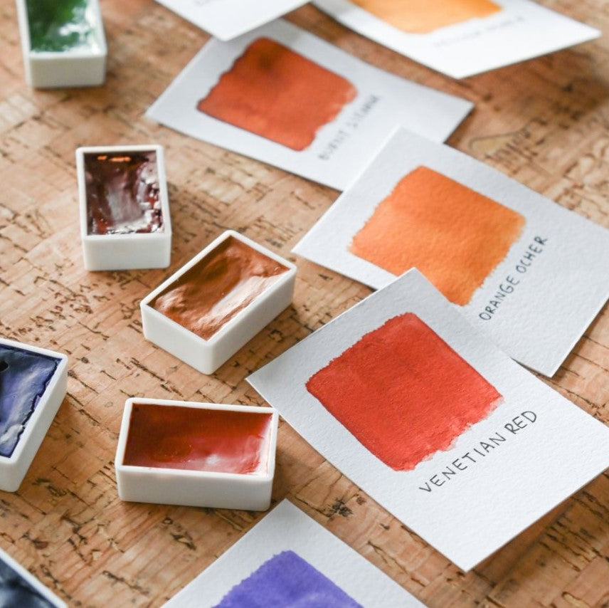Color swatches and paint samples on a wooden surface