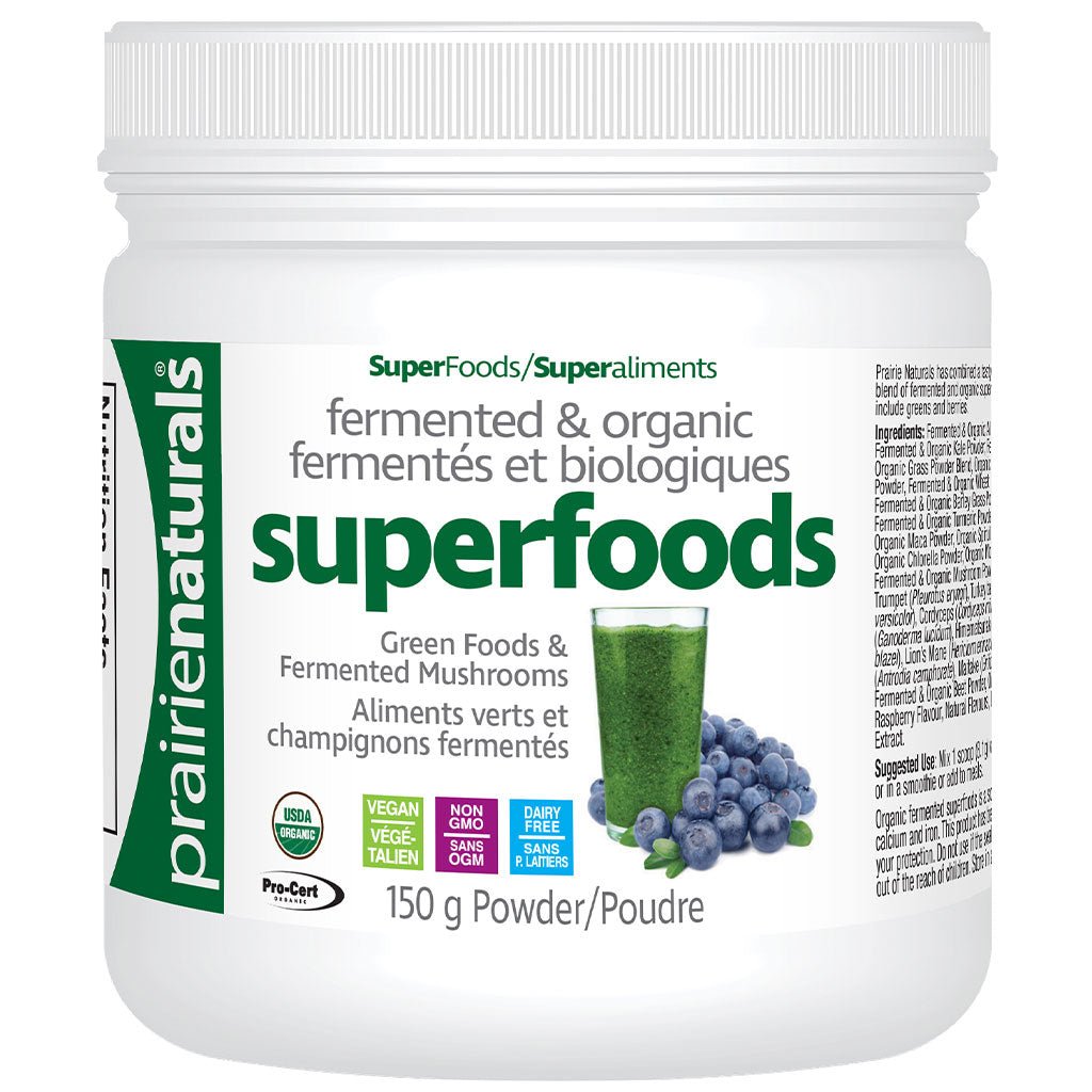 prairienaturals SuperFoods/Superaliments Superfoods powder, featuring green and black text on the label, along with an illustration of green juice and blueberries. The label also displays USDA Organic and Non-GMO badges.