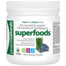 prairienaturals SuperFoods/Superaliments Superfoods powder, featuring green and black text on the label, along with an illustration of green juice and blueberries. The label also displays USDA Organic and Non-GMO badges.