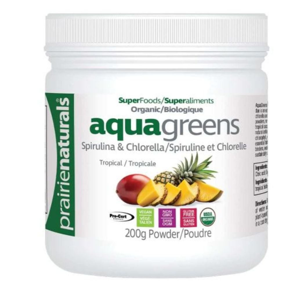 A white plastic jar of prairienaturals Aqua Greens powder, featuring a white label with green and black text, and illustrations of tropical fruits including pineapple, mango, and oranges.