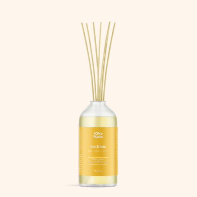 Reed diffuser with a yellow label on a white background