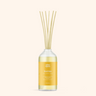 Reed diffuser with a yellow label on a white background