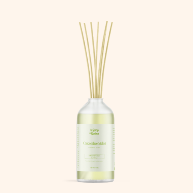 Diffuser bottle with wooden sticks on a white background