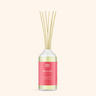 Reed diffuser with a pink label on a white background