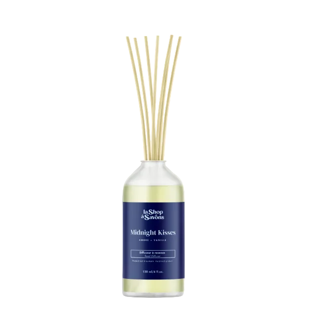 Diffuser with reeds labeled 'Midnight Kisses' on a light beige background
