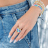 Close-up of a hand wearing a Miyuki Ring - Rainbow from Pinky Mimosa