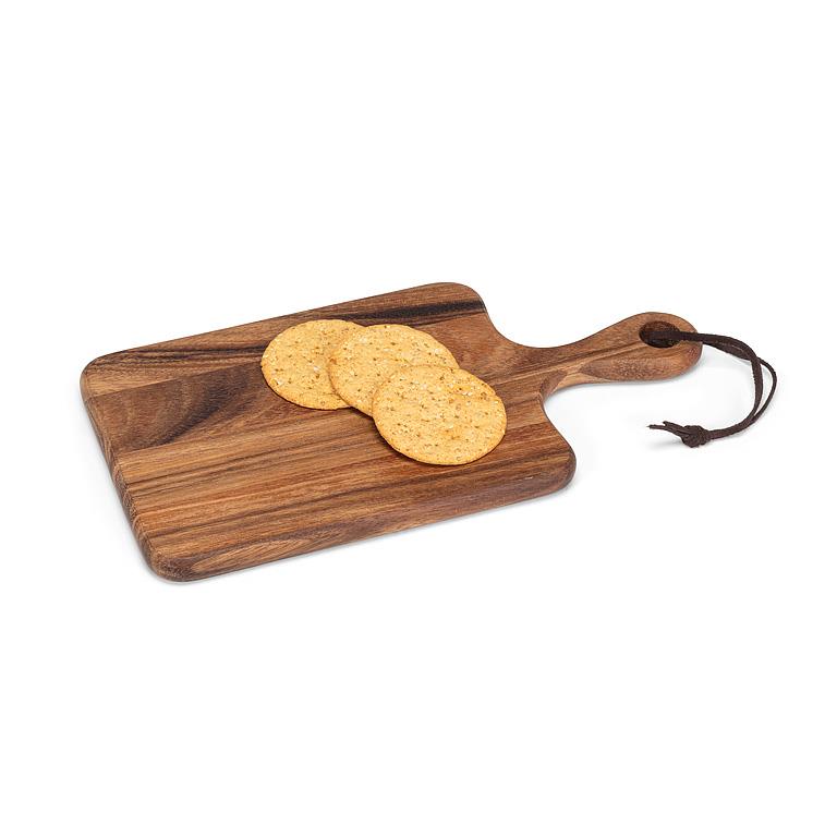 Wooden cutting board with a handle holding two crackers on a white background