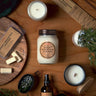 Candle and product set on a wooden surface with 'Rocky Mountain Juniper' branding.