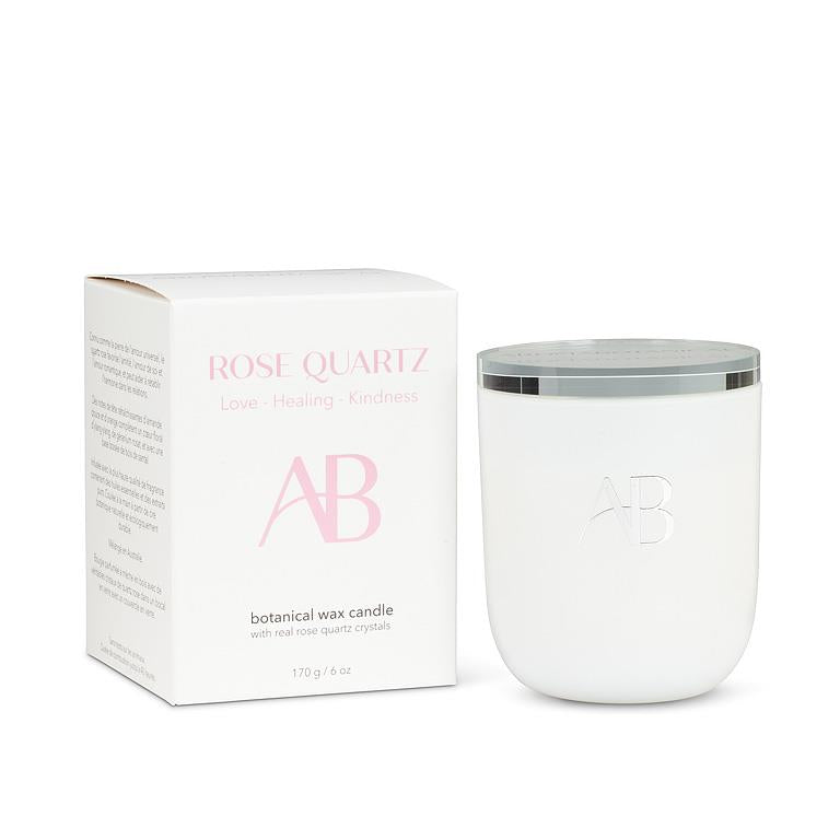 White candle with silver lid and matching box on a white background