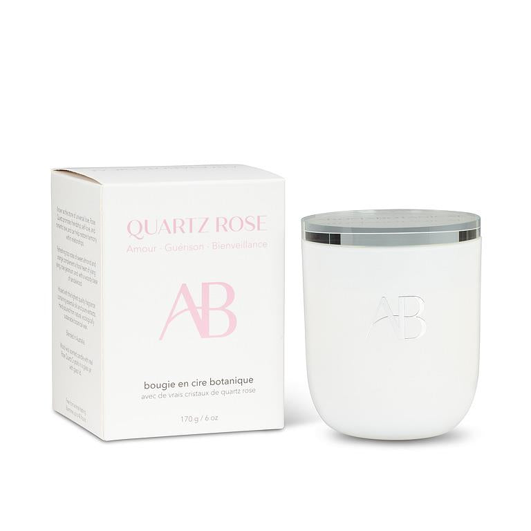 White candle with a silver lid next to its packaging on a white background