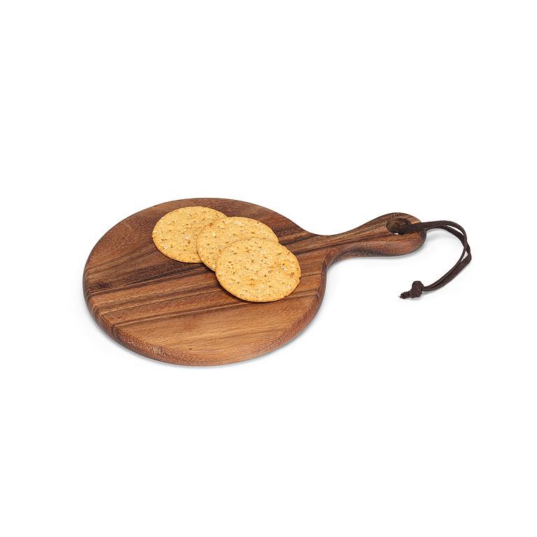 Wooden round cutting board with a handle, holding two crackers on a white background