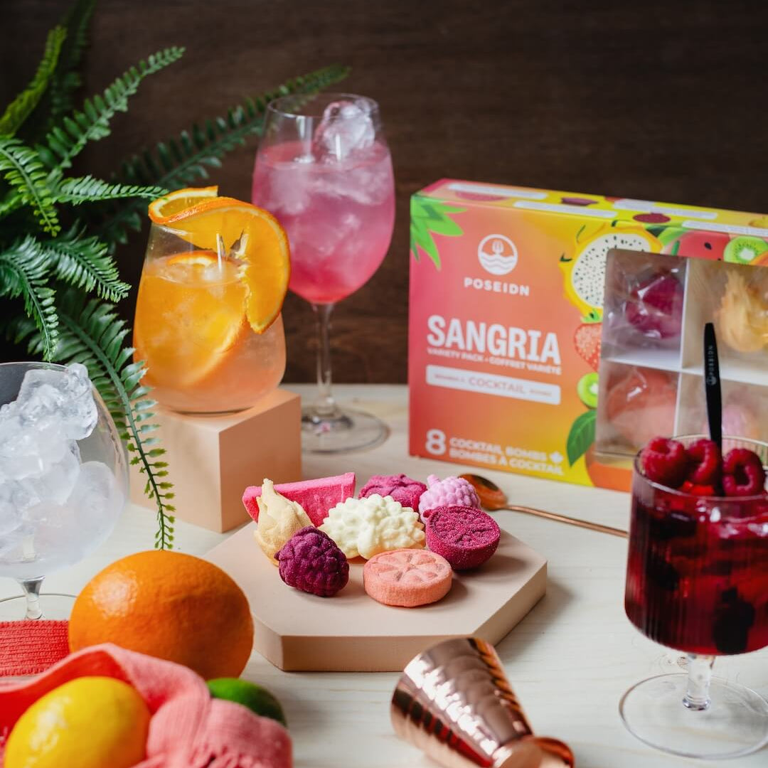 Sangria ingredients and mixers on a table with a box of POSEIDON Sangria mix.