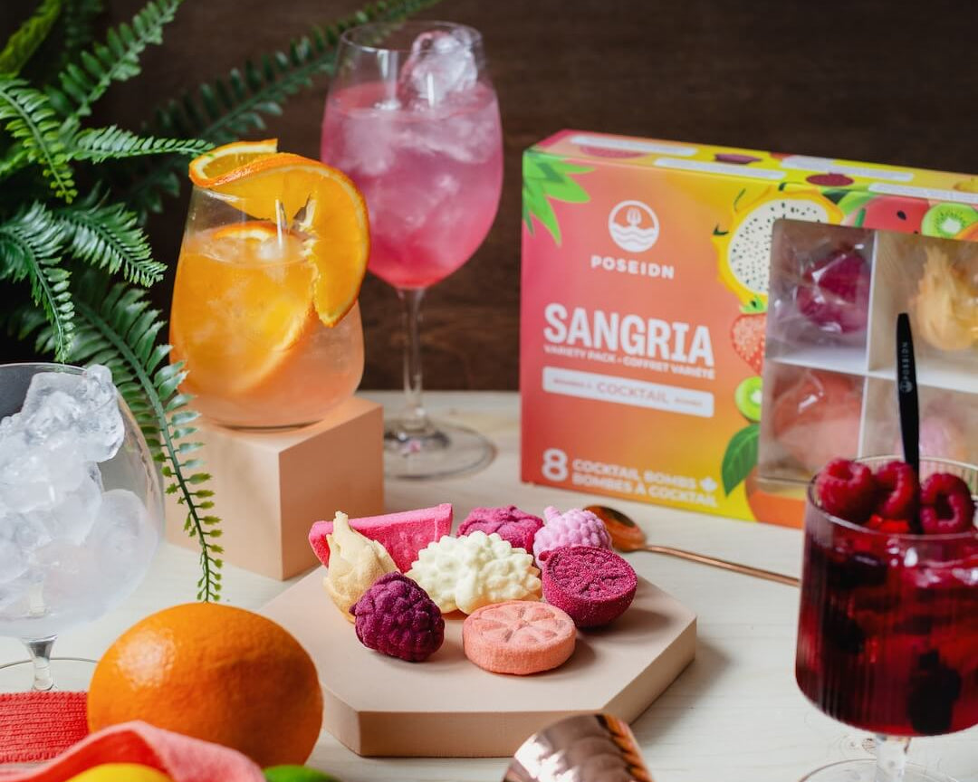 Sangria ingredients and mixers on a table with a box of POSEIDON Sangria mix.
