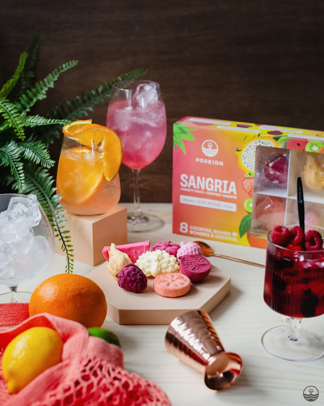 Sangria ingredients and mixers on a table with a box of POSEIDON Sangria mix.