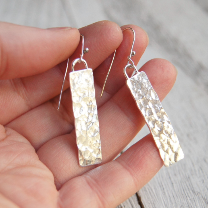 Close-up of Juliet925 Monolith earrings with hammered silver rectangles