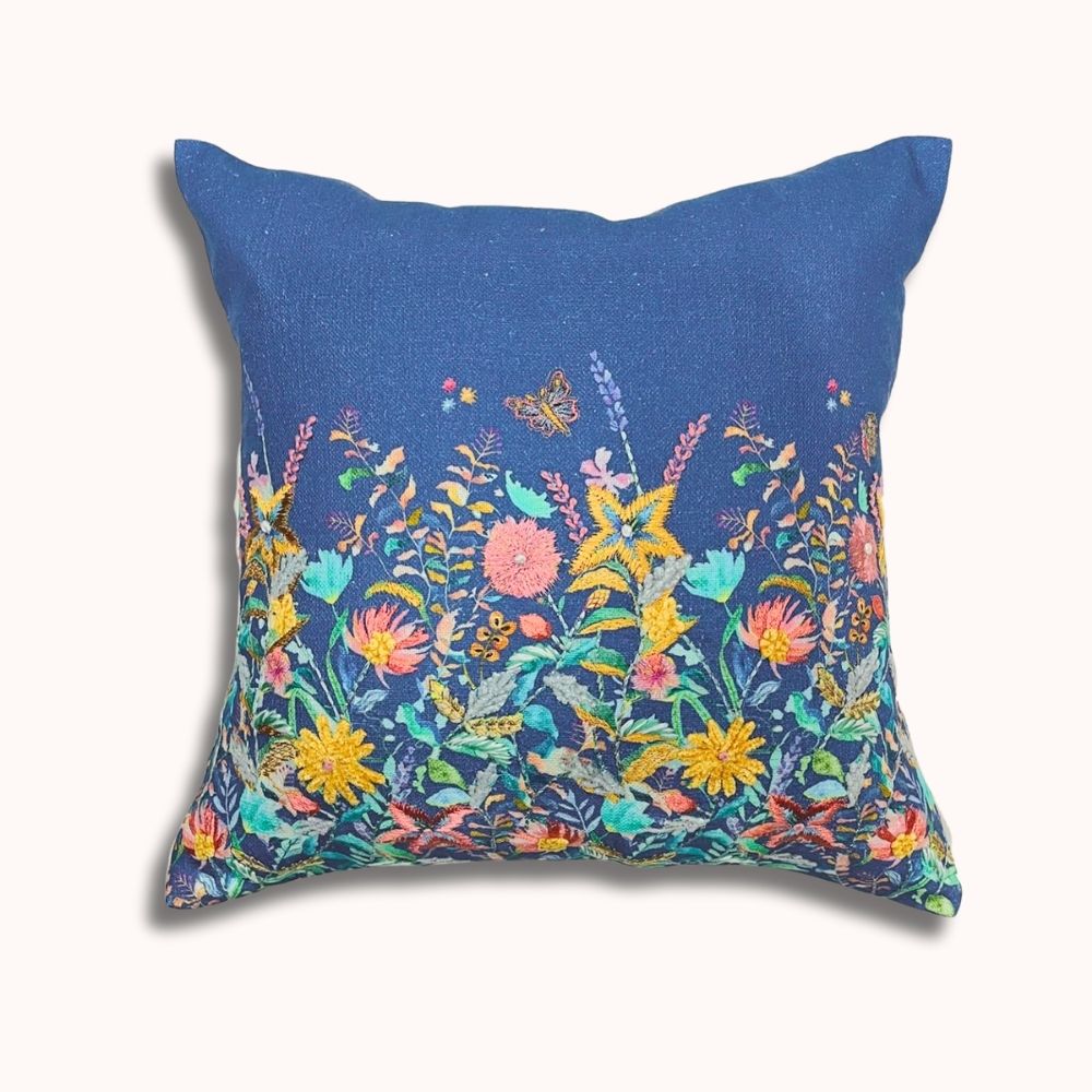 Decorative pillow with floral pattern on a blue background