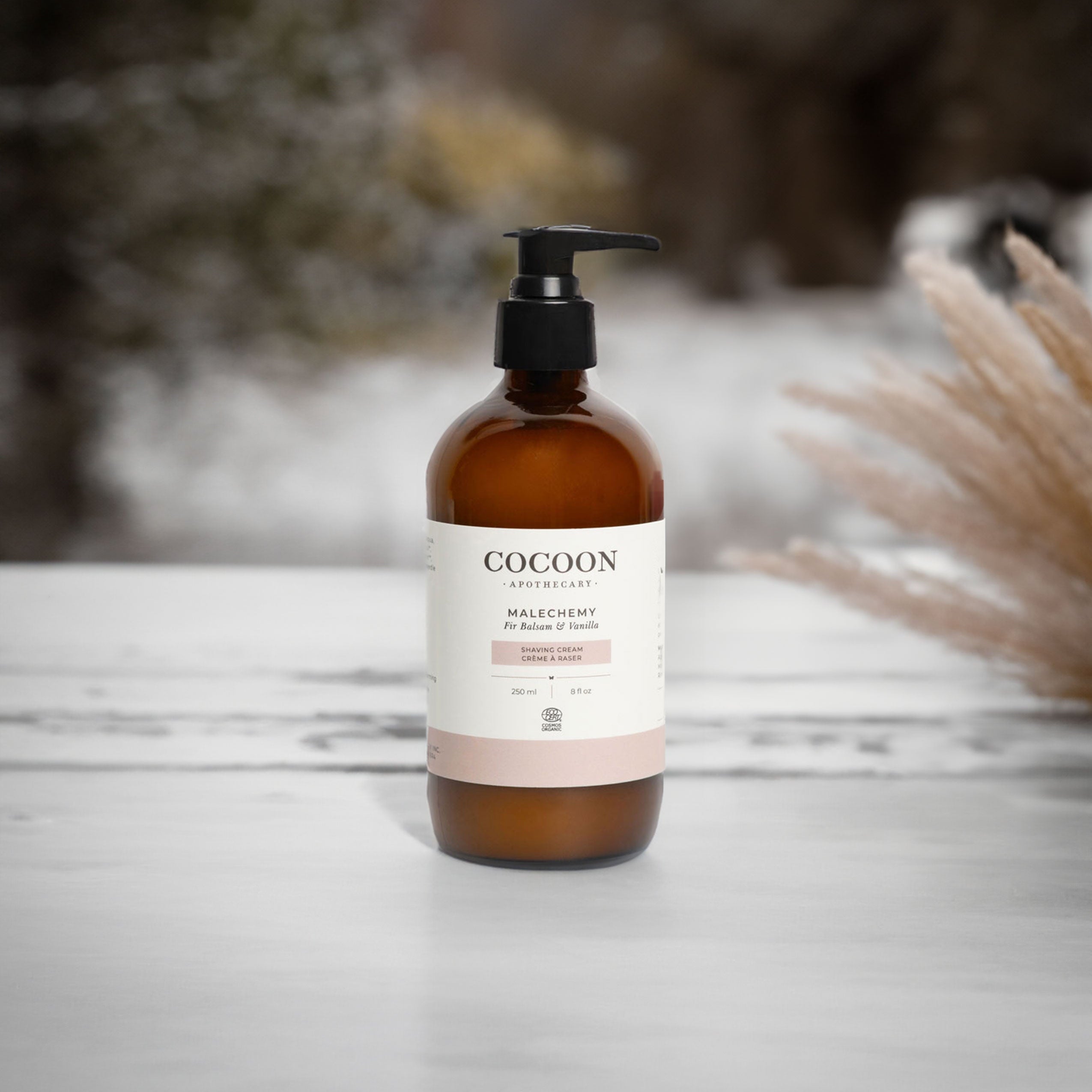 Cocoon bottle on a wooden surface with blurred natural background