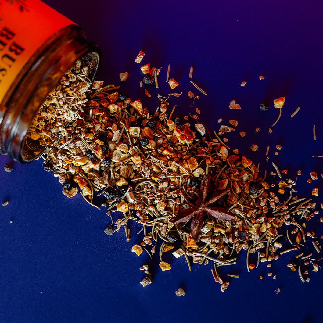 Spices spilling out of a jar on a blue background